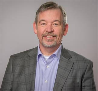 A headshot of Chris Becraft